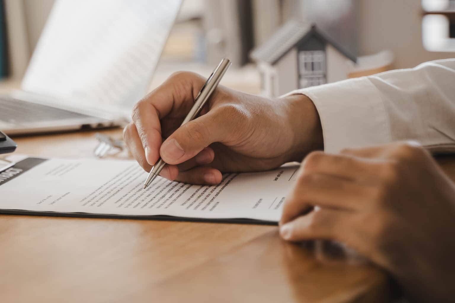 Hand of landlord, realtor pointing sign signature contract rental, purchase, buyer home or apartment with tenant, client after banker agreement mortgage, loan success or done. Property agent concept.